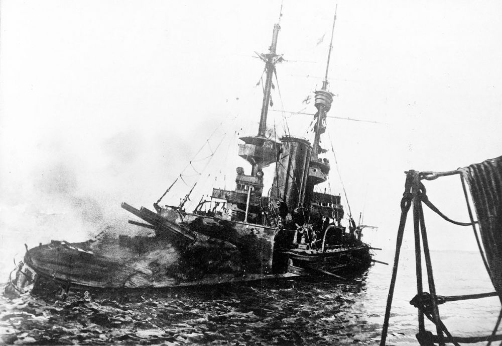 The HMS Irresistible listing heavily after the explosion of a floating mine.